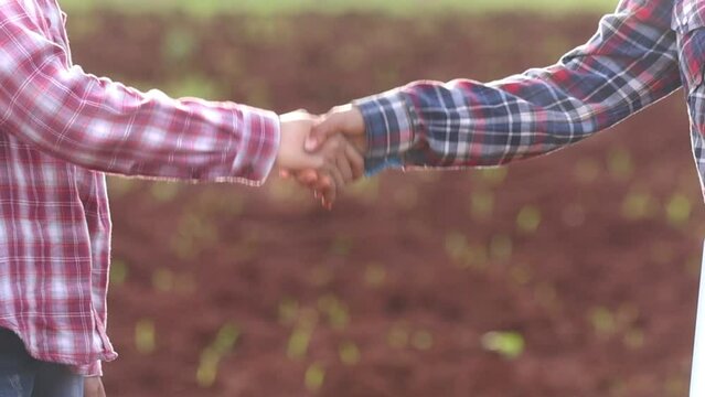 Farmers handshake in agriculture field. Agricultural contract
