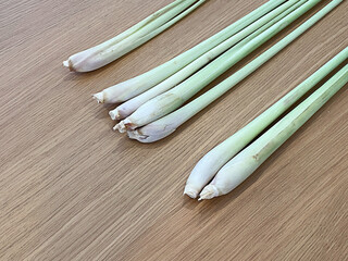 A group of lemongrass on wooden table.