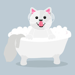 cute and beautiful doggy bathes in the bathtub and smiles with bubbles and a towel
