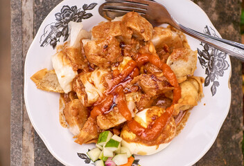Indonesian food - Batagor is made from fish, tapioca and seasoning wrapped in dumplings then fried. Served with spicy peanut sauce. indonesian streetfood