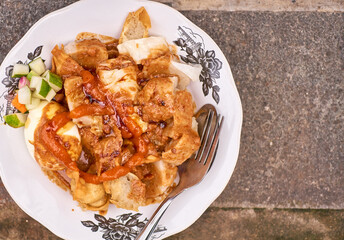 Indonesian food - Batagor is made from fish, tapioca and seasoning wrapped in dumplings then fried. Served with spicy peanut sauce.