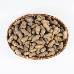 selective focus on peanuts on a basket made of woven bamboo