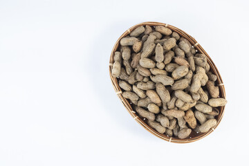 selective focus on peanuts on a basket made of woven bamboo