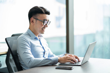 Asian businessman male portrait at his workplace