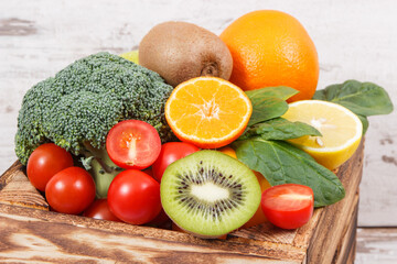 Fruits with vegetables in box as food containing minerals and vitamins, diet and slimming concept