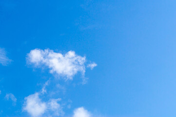 Beautiful blue sky texture with little strange white cloud and clear light under shining from the sun for background