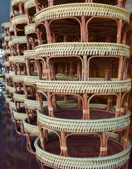 The wooden woven food trays are stacked on top of each other.