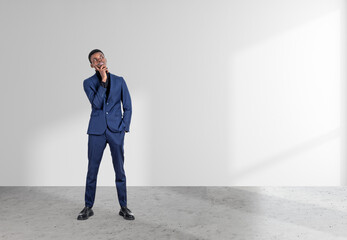 Black businessman with pensive look on white background. Copy space
