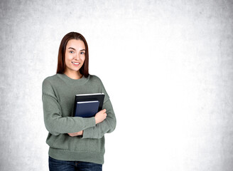 Attractive businesswoman wearing casual wear is standing holding