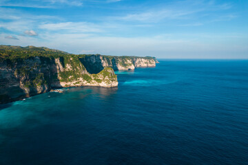 Aerial drone shot panoramic view of rocky cliff. Indian ocean shore. Copy space for text. Nature and travel background. Beautiful natural summer vacation travel concept.