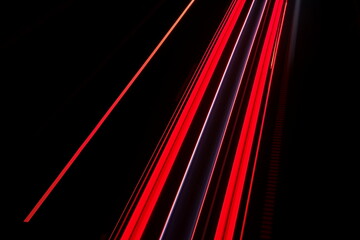 Night traffic. Streaks of tail lights at a long exposure. Geometric abstract