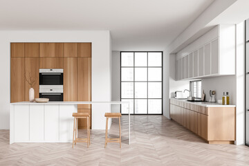 Light kitchen interior with island and seats, appliances and panoramic window