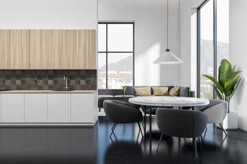 Studio interior with eating area and relax space, kitchen shelves, panoramic window