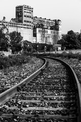 An abandoned rail tracks and a functional railroad in Montreal with rusty rails