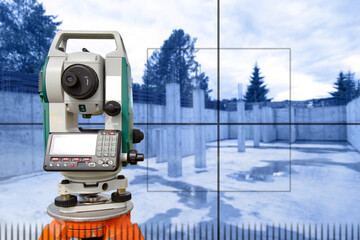 Geodetic instrument. Optical theodolite in front of building under construction. Geodetic device next to foundation. Topographic surveys during construction. Equipment geodetic sale. Surveyor device