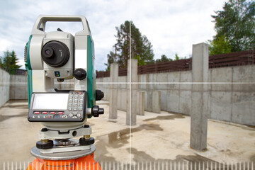 Device for surveyor. Optical theodelite on tripod. Electronic device for surveyor. Equipment for creating topographic maps. Theodelite in front of foundation. Art focus. Copy space about geodesy.