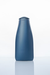 Blue plastic shampoo bottle on a white background
