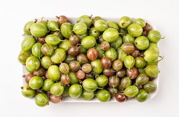 fresh ripe gooseberries texture on a plate, flat lay