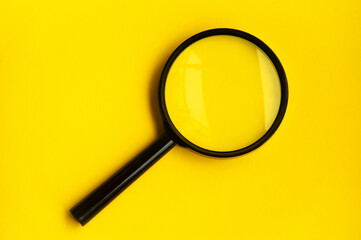 Blank magnifying glass on blue yellow background.