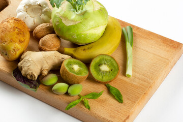 various vegetables and fruits on the cutting board