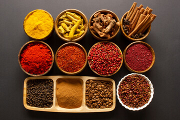 various spices on black background