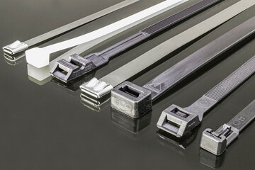 Various types of clamps for fastening electrical wires. Plastic and metal screeds. Electrician....