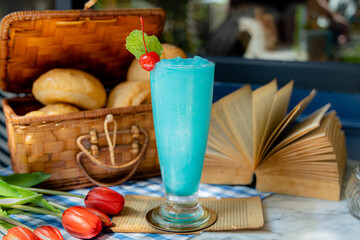 blue hawaiiaRefreshing Blue Hawaii Frappe Drink with Cherry and Mint.Vertical Image