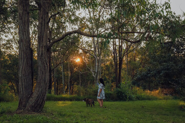 Woman in beautiful forest setting with lovely American Bulldog