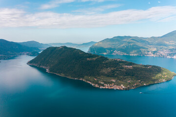 Fototapeta premium Beautiful aerial view of Torbole, Lake Garda (Lago di Garda) and the mountains, Italy. Scenic aerial view of Riva del Garda town, located on a shore of Garda lake. 