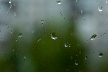 summer rain drops on glass with city background