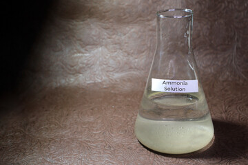Ammonia Solution in flask with a lid on a brown background. Ammonia Solution chemical reagent...