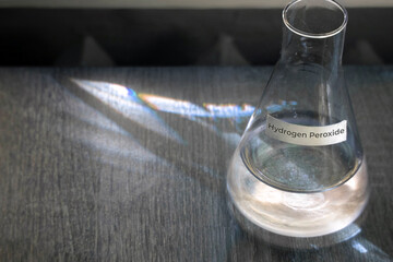 Hydrogen Peroxide in a glass flask - top view. The concept of the chemical reagent Hydrogen...