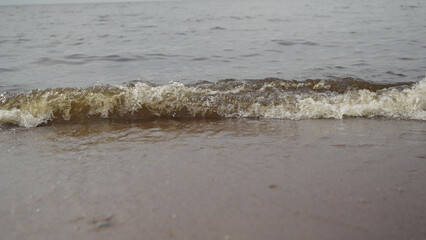 closeup shot of waves rolling on a beach on Baltic Sea