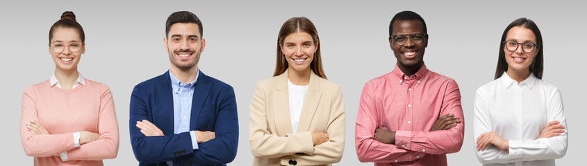 Business management team as a group of diverse executive people standing with folded arms isolated