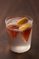 Grapefruit lemonade in tumbler glass on wood table