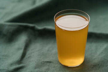 orange lemonade in a tumbler glass on linen cloth