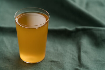 orange lemonade in a tumbler glass on linen cloth