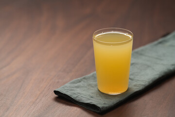 Lemonade in tumbler glass on linen napkin with copy space