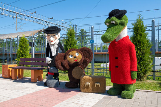 CHUDOVO, RUSSIA - JUNE 26, 2022: Characters of famous children's soviet cartoons crocodile Gena, Cheburashka and old woman Shapoklyak on the railway station platform on a sunny June day