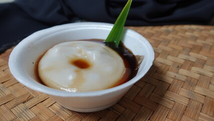 Bubur sumsum, rice porridge with palm sugar and pandan leaf