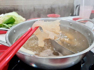 Slice jellyfish within hot pot soup