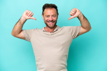 Middle age caucasian man isolated on blue background proud and self-satisfied