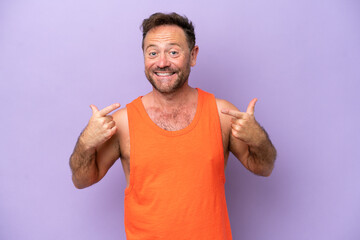 Fototapeta premium Middle age caucasian man isolated on purple background giving a thumbs up gesture
