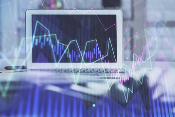 Forex market chart hologram and personal computer background. Double exposure. Concept of investment.