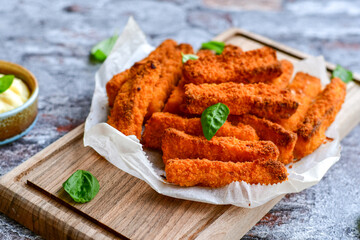 Close up of   Crispy breaded  deep fried fish fingers with breadcrumbs served  with remoulade sauce...