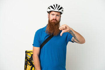 Young reddish caucasian man with thermal backpack isolate don white background showing thumb down with negative expression