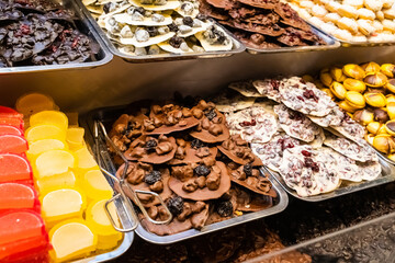 assorted handmade chocolate with various fillings, prunes and cranberries
