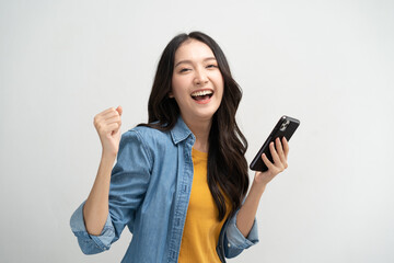 Happy Asian woman holding a smartphone and winning the prize.