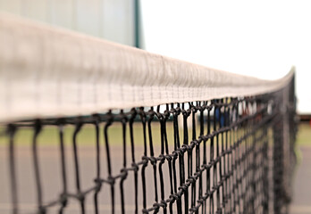 Blur, or bokeh, of a camera on a tennis court net