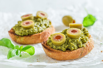 Hot and crisp bruschetta with black olives for breakfast.